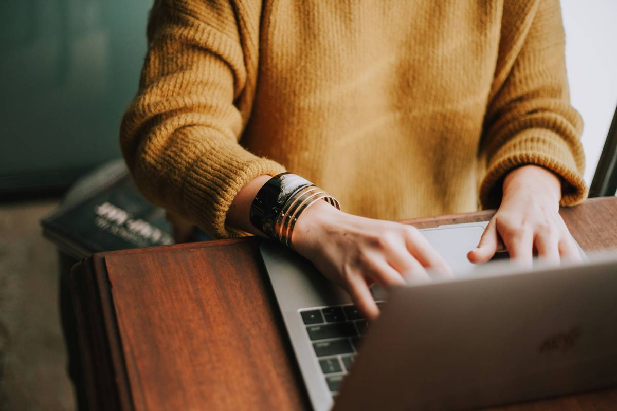 woman studying languages on tablet with notebook showing progress chart; self improvement duolingo alternative is effective